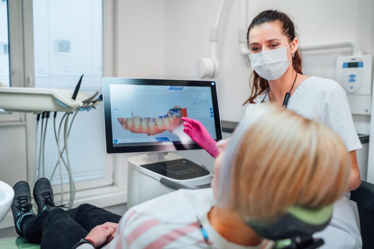 a female dentist going over a scan with her patient